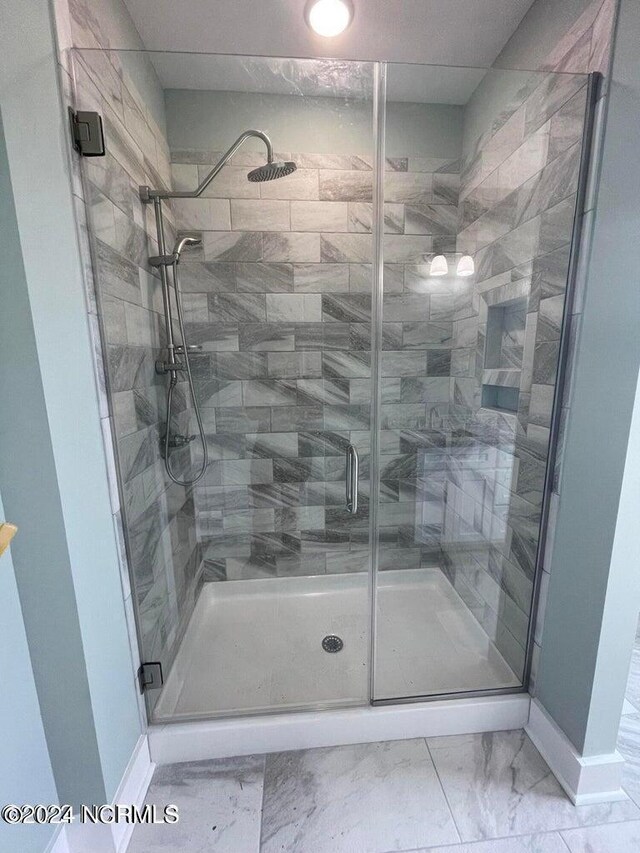 bathroom featuring an enclosed shower and tile patterned flooring