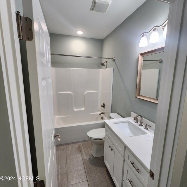 full bathroom with vanity, shower / bath combination, and toilet