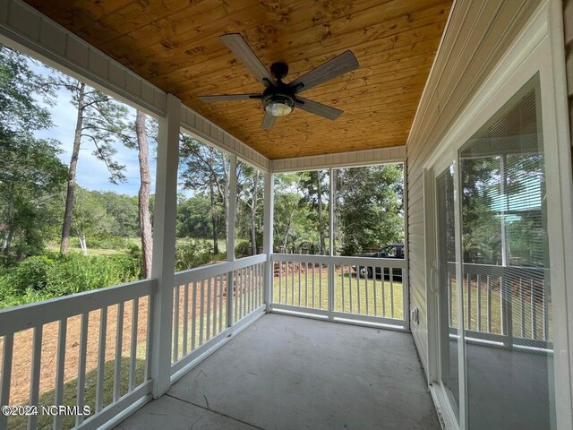 exterior space featuring ceiling fan and wooden ceiling