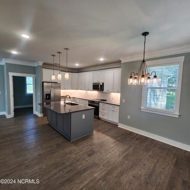 kitchen with decorative backsplash, appliances with stainless steel finishes, dark hardwood / wood-style flooring, and white cabinetry