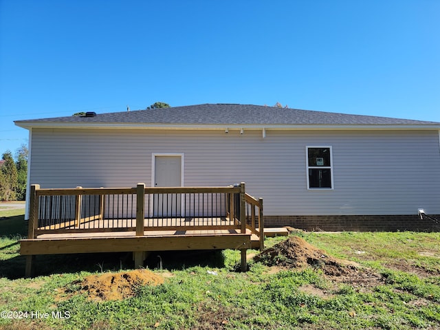 back of house with a deck