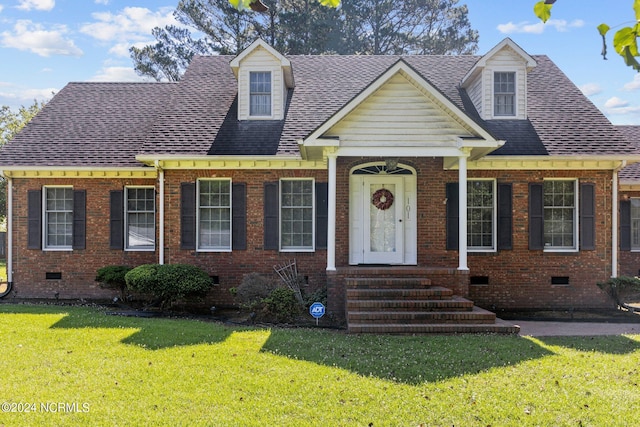 cape cod home with a front lawn