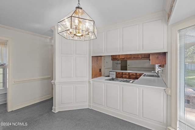 kitchen with ornamental molding, stainless steel gas stovetop, sink, an inviting chandelier, and hanging light fixtures