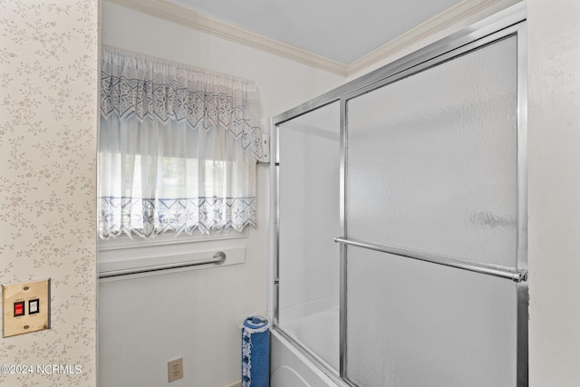 bathroom featuring crown molding and enclosed tub / shower combo