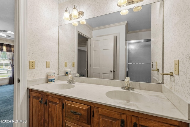 bathroom with crown molding, vanity, and a shower with shower door