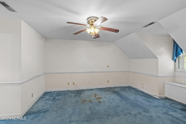 bonus room with carpet flooring and ceiling fan