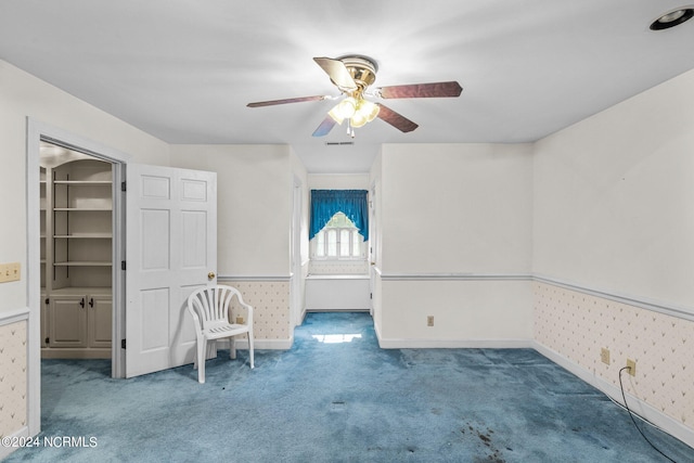 unfurnished room with carpet flooring and ceiling fan