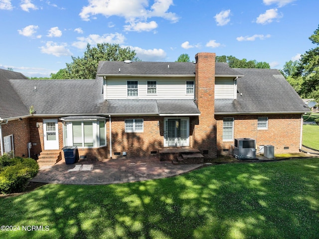 back of property featuring a lawn, central AC unit, and a patio