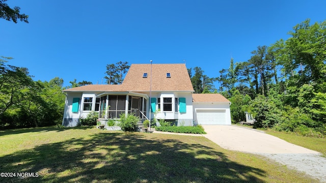 new england style home with a garage and a front lawn