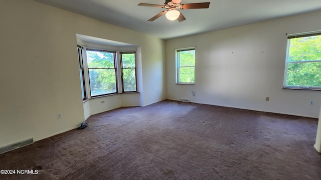 spare room with carpet floors and ceiling fan