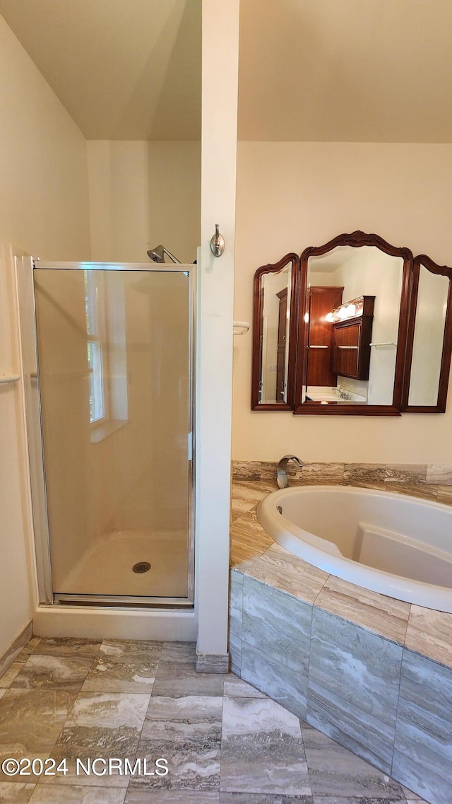 bathroom with tile floors and independent shower and bath