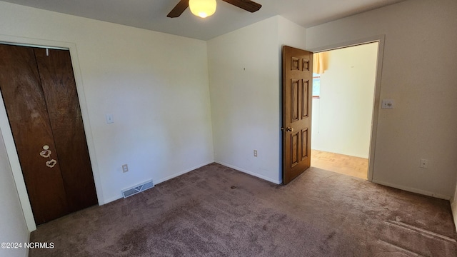 unfurnished bedroom with carpet flooring, a closet, and ceiling fan