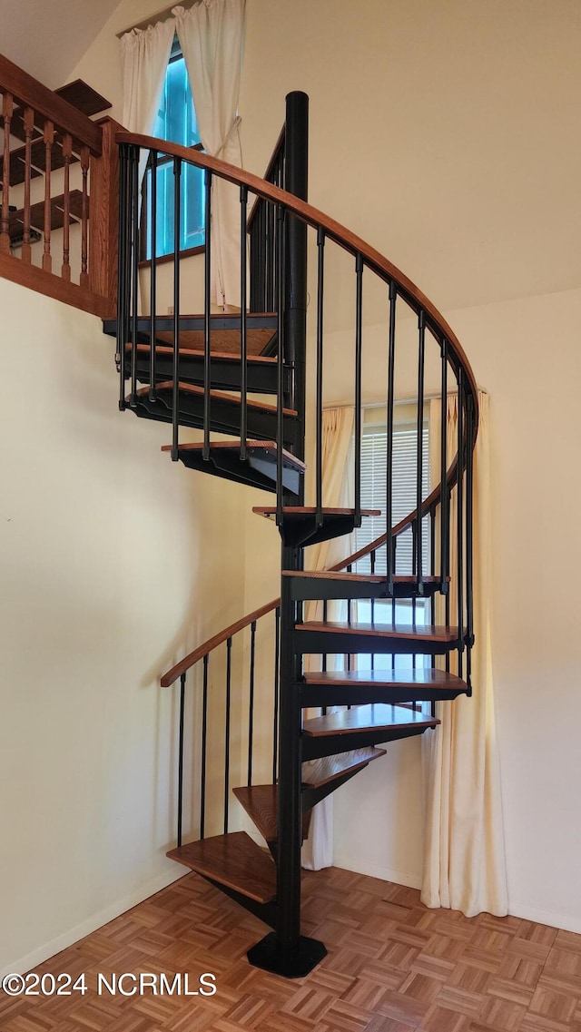 stairs with vaulted ceiling and parquet flooring