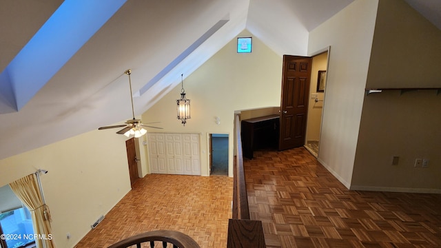 interior space with lofted ceiling, ceiling fan, and parquet flooring