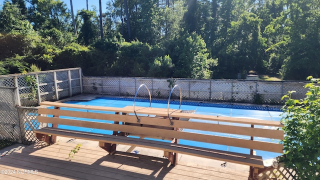 view of swimming pool featuring a deck