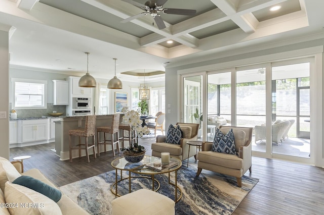 living room featuring dark hardwood / wood-style flooring, ornamental molding, plenty of natural light, and coffered ceiling