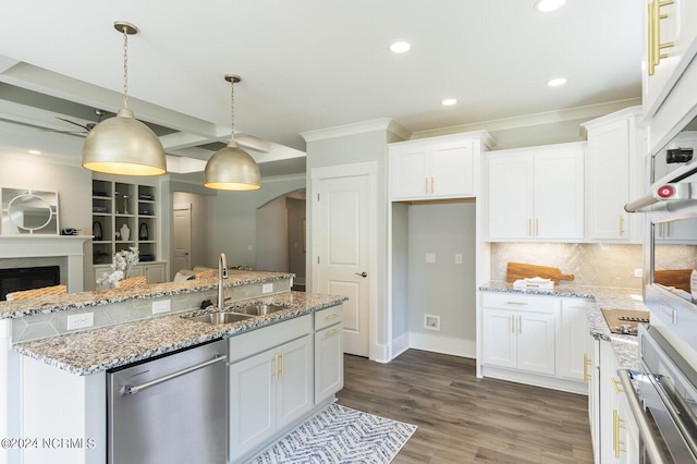 kitchen with sink, an island with sink, white cabinets, decorative light fixtures, and stainless steel dishwasher