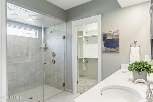 full bath with a shower stall, a sink, and double vanity
