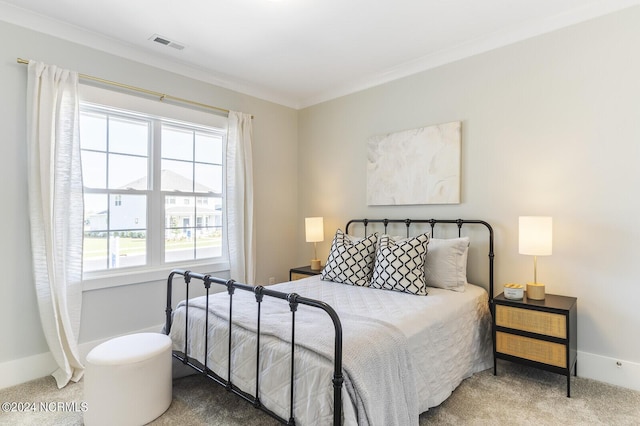 bedroom featuring baseboards, ornamental molding, and carpet