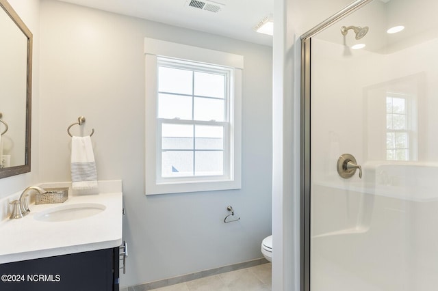 bathroom with tile patterned floors, vanity, toilet, and a shower with door