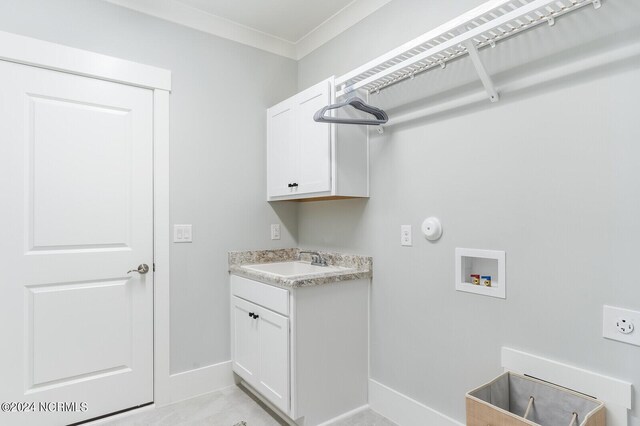 laundry area with washer hookup, sink, crown molding, and cabinets