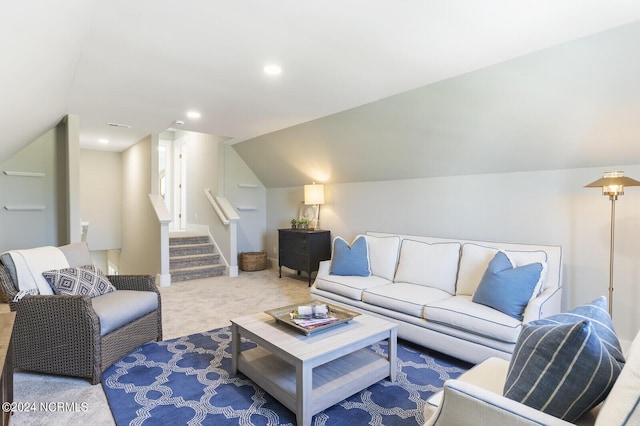 carpeted living area featuring vaulted ceiling, recessed lighting, and stairway