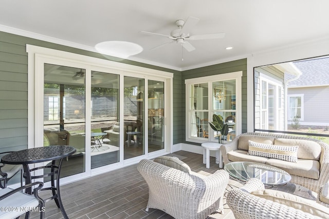 sunroom featuring ceiling fan