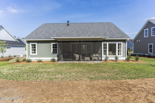 back of house with a yard and a sunroom