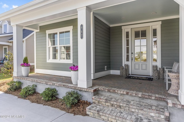 entrance to property featuring covered porch