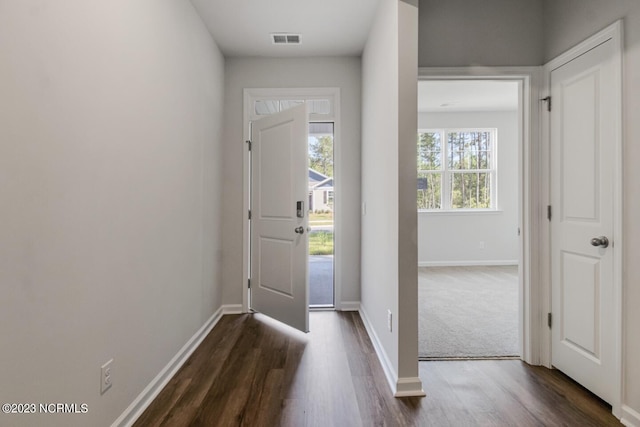 foyer with dark carpet