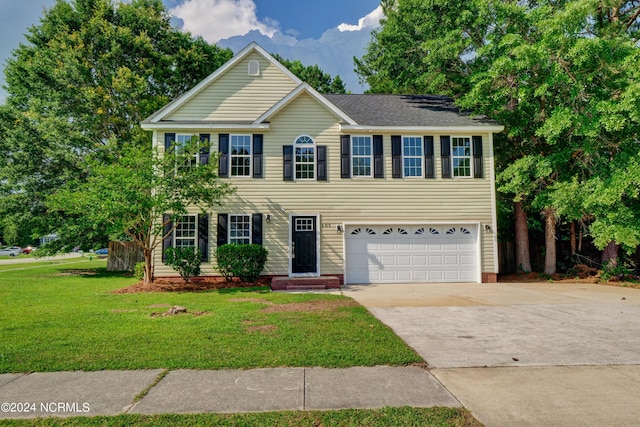 view of front of property featuring a garage and a front lawn