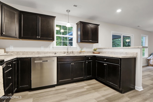 kitchen with pendant lighting, stainless steel dishwasher, sink, and light wood-type flooring