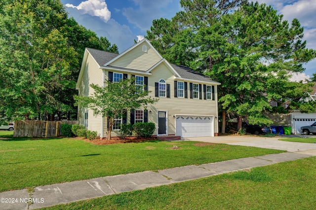 view of front of home with a garage and a front lawn