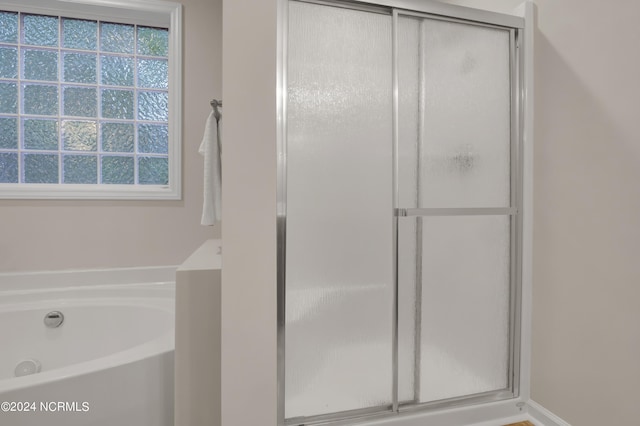 bathroom with shower with separate bathtub