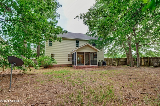 back of property with a sunroom and cooling unit