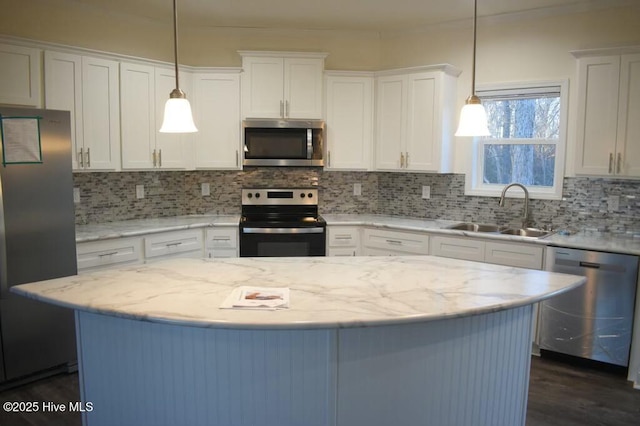 kitchen featuring white cabinetry, sink, hanging light fixtures, and appliances with stainless steel finishes