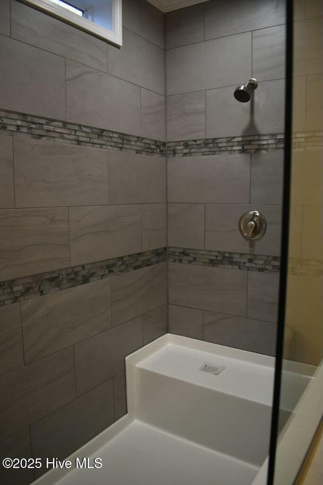 bathroom with tiled shower