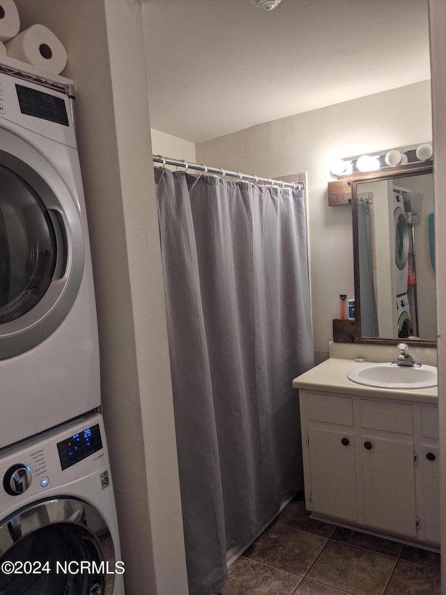 bathroom featuring stacked washer and dryer and vanity