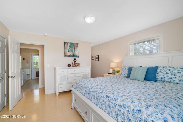 bedroom featuring separate washer and dryer