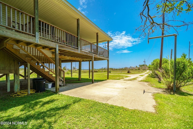 view of patio with a wooden deck and a rural view