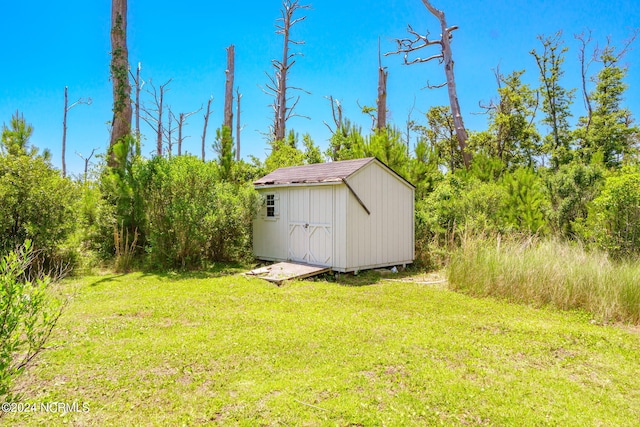 view of outbuilding with a yard