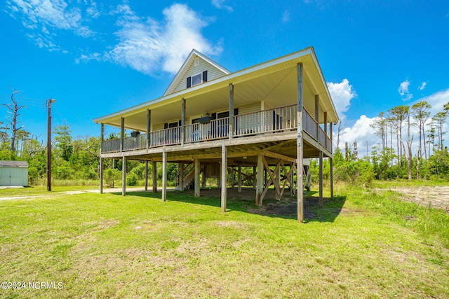 back of house featuring a wooden deck and a lawn