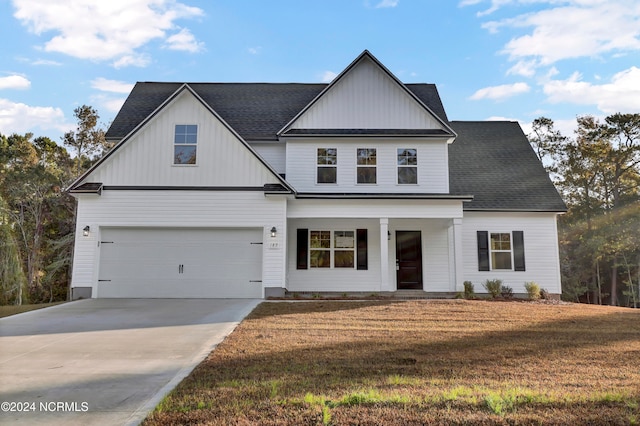 view of front of property featuring a front yard and a garage