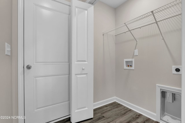 laundry room featuring dark wood-type flooring, hookup for a washing machine, and electric dryer hookup