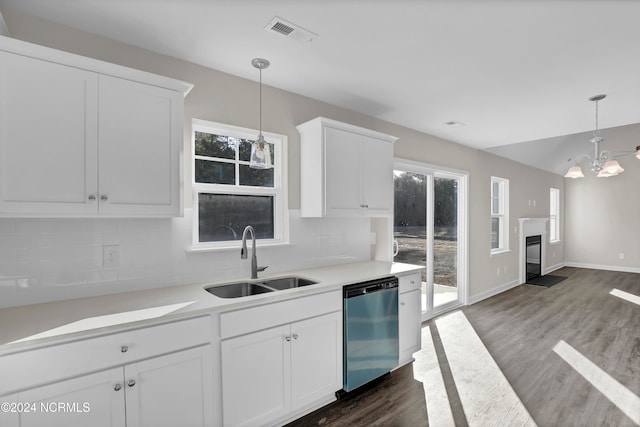 kitchen with sink, dishwasher, hanging light fixtures, white cabinets, and dark wood-type flooring