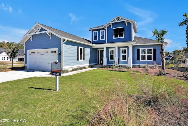 craftsman inspired home featuring a front lawn and a garage