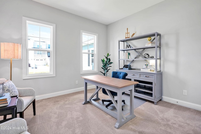 home office with light colored carpet and baseboards