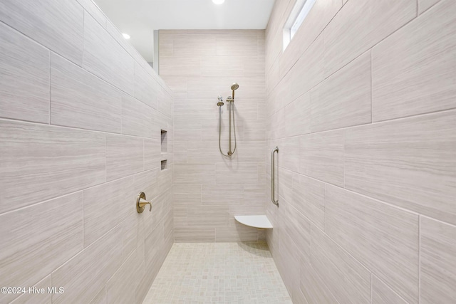 full bathroom featuring tiled shower