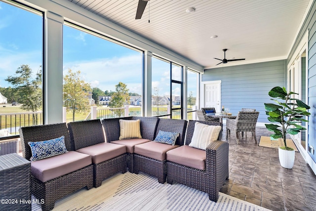 sunroom / solarium featuring ceiling fan and an outdoor hangout area