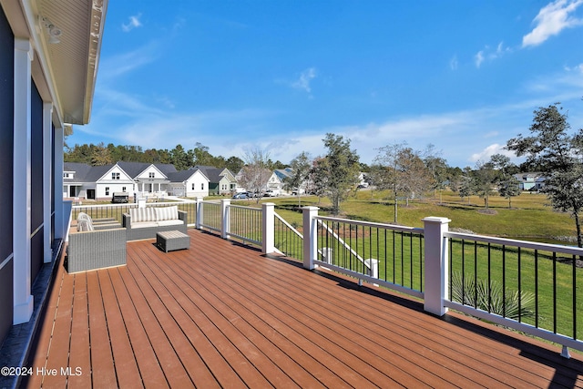 deck with a residential view and a lawn